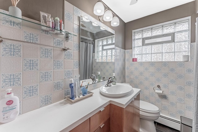 5626 S Nashville Ave, Chicago, IL 60638 - bathroom featuring baseboard heating, toilet, vanity, and tile walls