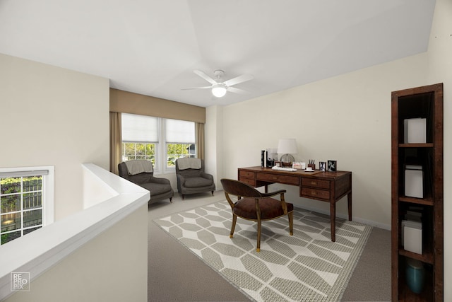 office featuring light carpet, a ceiling fan, and baseboards