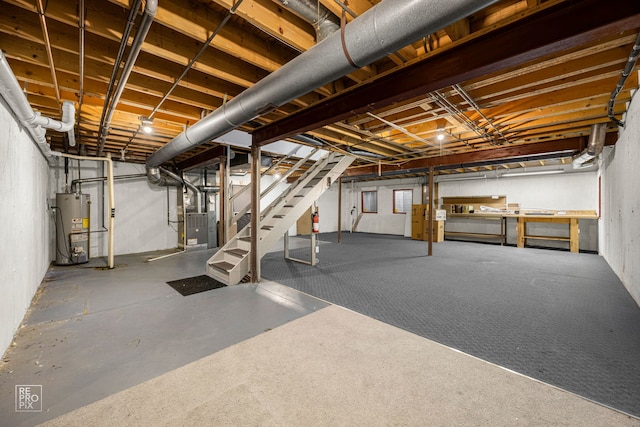 unfinished basement with water heater, stairs, and heating unit