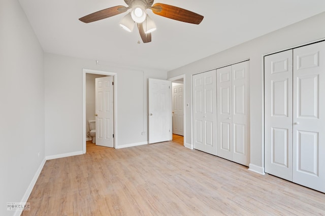 unfurnished bedroom with a ceiling fan, connected bathroom, multiple closets, light wood-type flooring, and baseboards