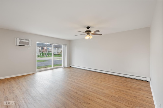 empty room featuring a baseboard heating unit, ceiling fan, wood finished floors, and a wall mounted AC