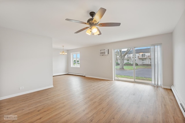 empty room featuring baseboards, light wood-type flooring, baseboard heating, and ceiling fan with notable chandelier