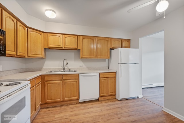 kitchen with baseboard heating, a sink, white appliances, light wood-type flooring, and light countertops