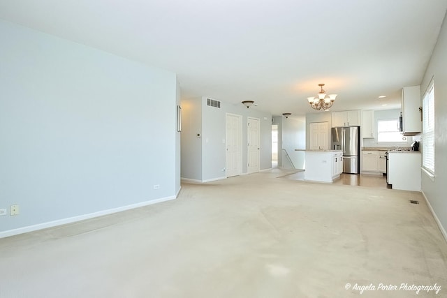 1244 Chesterton Dr Unit 1244, Fox Lake, IL 60020 - unfurnished living room with visible vents, light carpet, baseboards, and a chandelier