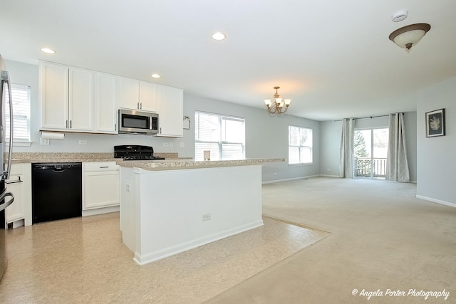 1244 Chesterton Dr Unit 1244, Fox Lake, IL 60020 - kitchen with plenty of natural light, light countertops, a notable chandelier, and black appliances