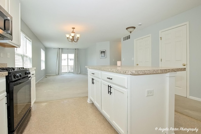1244 Chesterton Dr Unit 1244, Fox Lake, IL 60020 - kitchen featuring light carpet, stainless steel microwave, visible vents, a notable chandelier, and black gas range oven