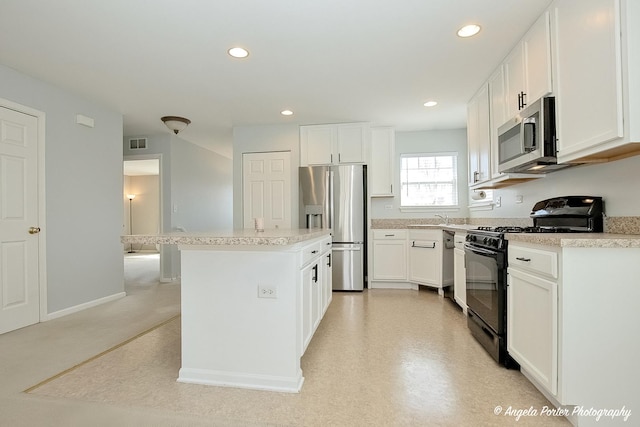 1244 Chesterton Dr Unit 1244, Fox Lake, IL 60020 - kitchen with white cabinets, visible vents, appliances with stainless steel finishes, and a center island