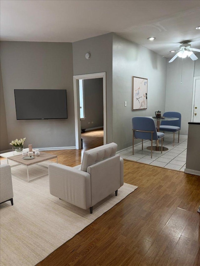 living area featuring recessed lighting, baseboards, a ceiling fan, and wood finished floors