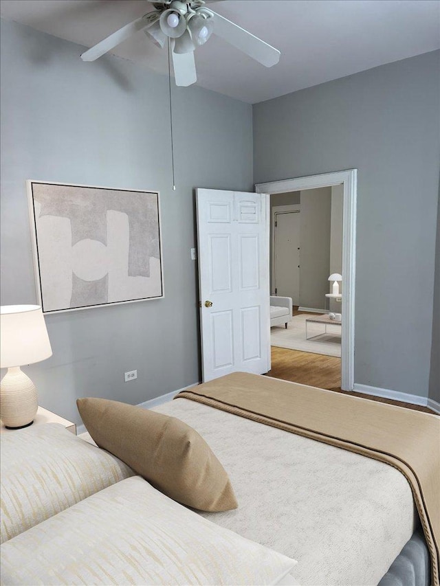 bedroom with baseboards, a ceiling fan, and wood finished floors