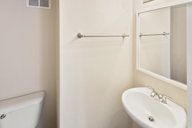 924 Symphony Dr Unit 7036, Aurora, IL 60504 - half bath featuring visible vents, toilet, and a sink