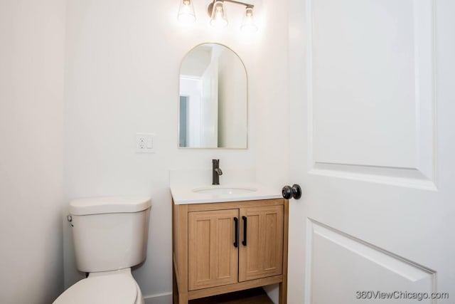 half bathroom with toilet and vanity