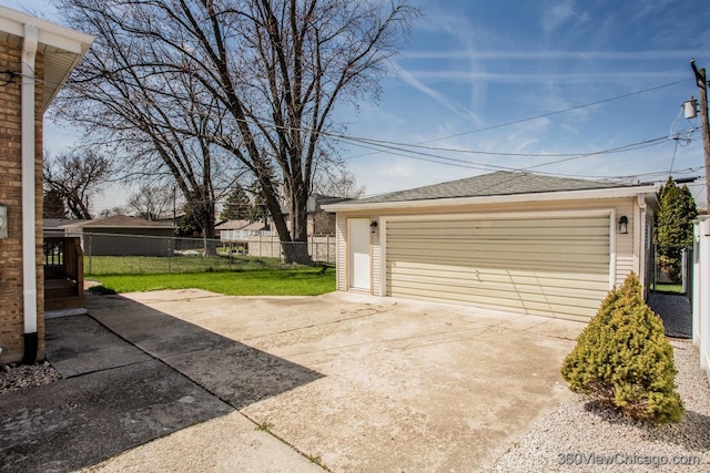 detached garage featuring fence