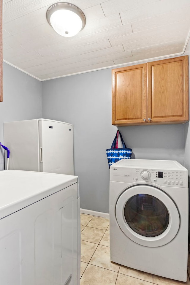 26 S Victoria Ln, Streamwood, IL 60107 - laundry area featuring cabinet space, baseboards, washer and dryer, and light tile patterned floors