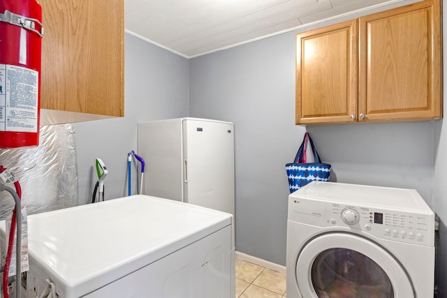 26 S Victoria Ln, Streamwood, IL 60107 - clothes washing area with cabinet space, washer and dryer, ornamental molding, and light tile patterned floors