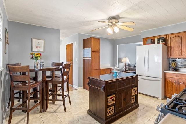 26 S Victoria Ln, Streamwood, IL 60107 - kitchen with freestanding refrigerator, brown cabinetry, decorative backsplash, and ceiling fan