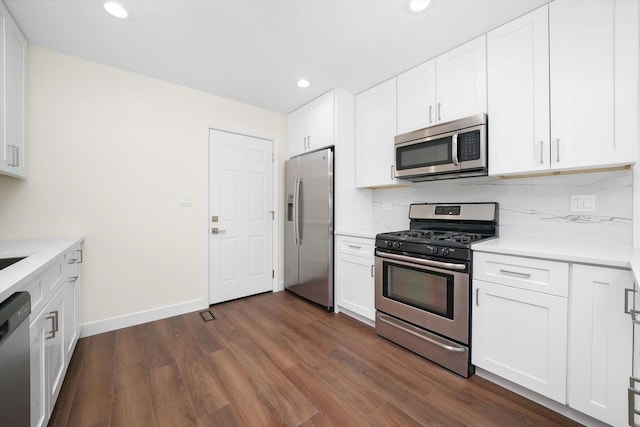 1 Fernwood Ct, Romeoville, IL 60446 - kitchen with appliances with stainless steel finishes, light countertops, recessed lighting, dark wood-style floors, and white cabinets
