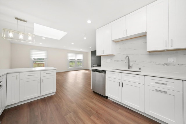 1 Fernwood Ct, Romeoville, IL 60446 - kitchen with dishwasher, a skylight, a sink, wood finished floors, and tasteful backsplash