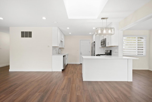 1 Fernwood Ct, Romeoville, IL 60446 - kitchen with stainless steel appliances, light countertops, white cabinetry, dark wood-type flooring, and baseboards
