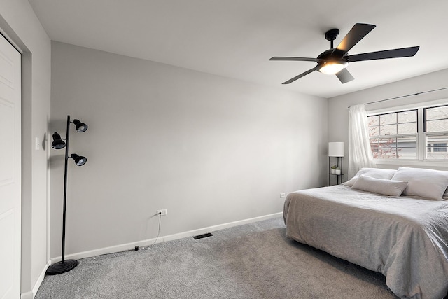 bedroom featuring carpet flooring, visible vents, baseboards, and ceiling fan
