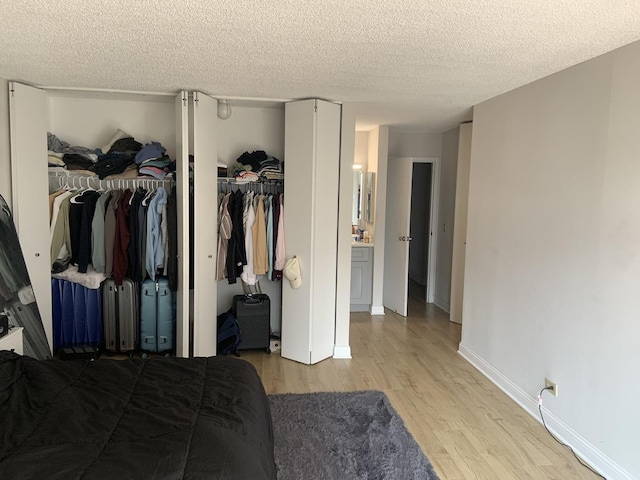 200 N Dearborn St Unit 2406, Chicago, IL 60601 - bedroom with light wood finished floors, a textured ceiling, and baseboards