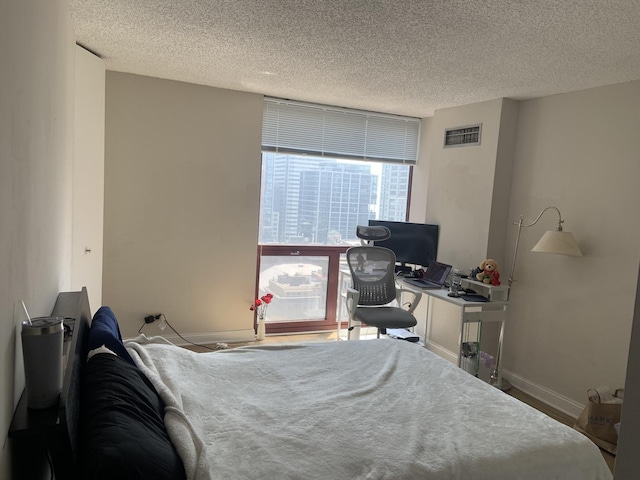200 N Dearborn St Unit 2406, Chicago, IL 60601 - bedroom with a textured ceiling and baseboards