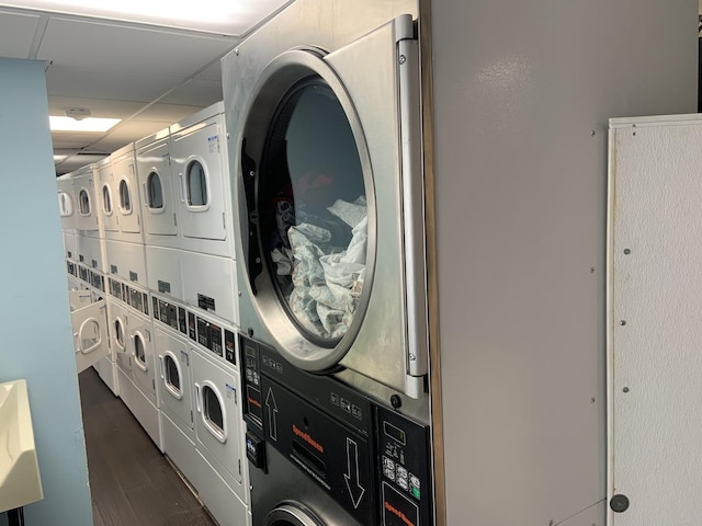200 N Dearborn St Unit 2406, Chicago, IL 60601 - community laundry featuring stacked washing machine and dryer, dark wood-style floors, and washing machine and dryer