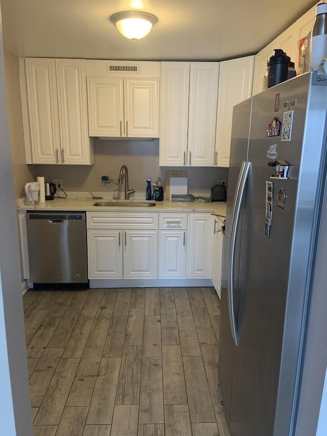 200 N Dearborn St Unit 2406, Chicago, IL 60601 - kitchen with stainless steel appliances, a sink, light countertops, and light wood-style flooring