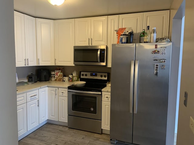 200 N Dearborn St Unit 2406, Chicago, IL 60601 - kitchen with stainless steel appliances, light wood-style flooring, and white cabinets