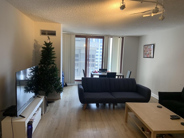 200 N Dearborn St Unit 2406, Chicago, IL 60601 - living area featuring wood-type flooring, a textured ceiling, and baseboards