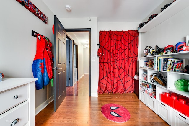 rec room with light wood finished floors and baseboards