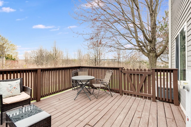 wooden terrace with outdoor dining area
