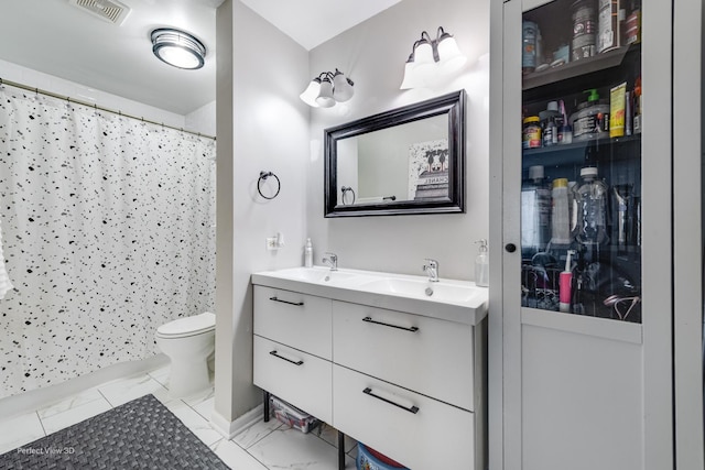 full bath with double vanity, visible vents, toilet, and a sink