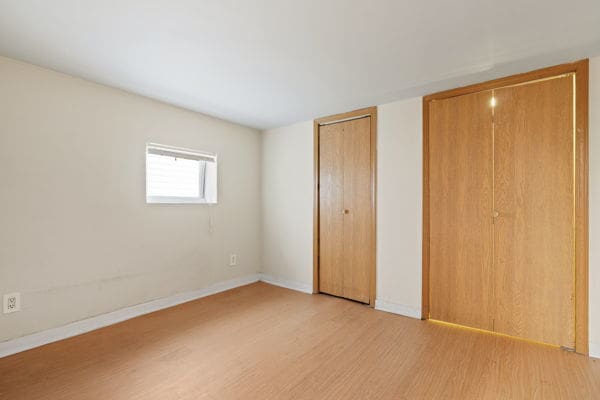 3507 N Osceola Ave, Chicago, IL 60634 - unfurnished bedroom with light wood-type flooring and multiple closets