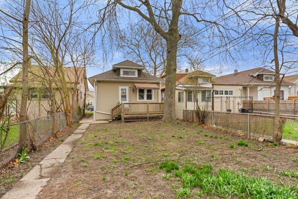 3507 N Osceola Ave, Chicago, IL 60634 - rear view of house with a wooden deck and a fenced backyard
