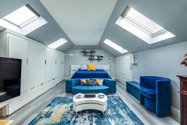 455 W 38th St, Chicago, IL 60609 - bedroom with baseboards, lofted ceiling with skylight, light wood-style flooring, and visible vents
