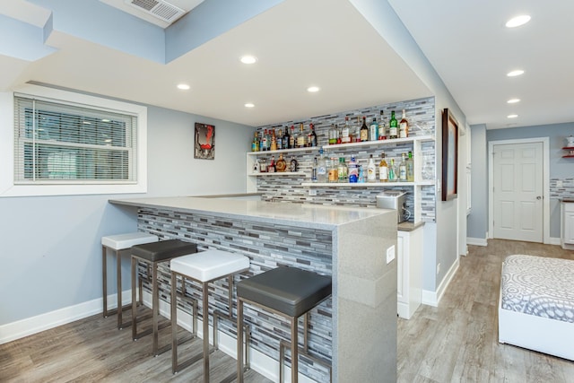 455 W 38th St, Chicago, IL 60609 - bar featuring a dry bar, light wood finished floors, recessed lighting, decorative backsplash, and visible vents
