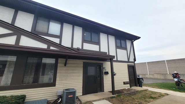 6084 Fremont Dr Unit 6084, Hanover Park, IL 60133 - back of property with stucco siding, cooling unit, and fence