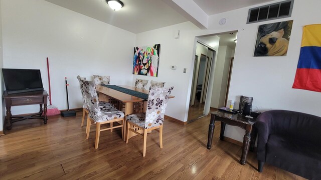 6084 Fremont Dr Unit 6084, Hanover Park, IL 60133 - dining area featuring visible vents, baseboards, and wood finished floors