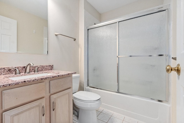 full bathroom featuring toilet, tile patterned flooring, enclosed tub / shower combo, and vanity