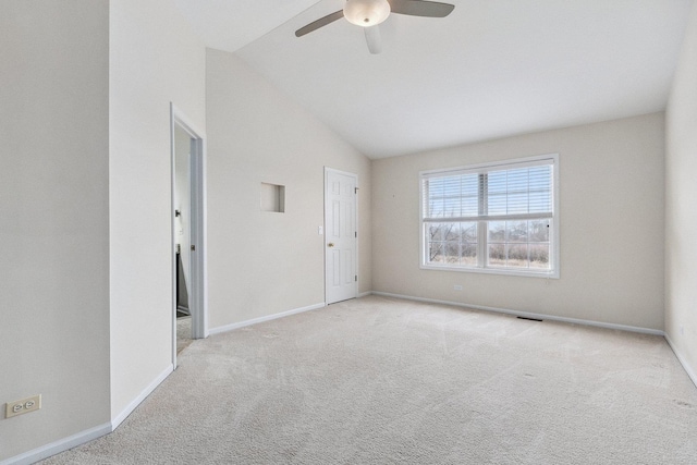 empty room with carpet, baseboards, vaulted ceiling, and ceiling fan