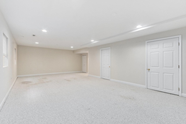 below grade area with baseboards, recessed lighting, and light carpet