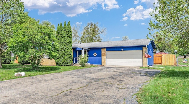 2240 Marilyn Dr, Saint Joseph, IL 61873 - view of front of house featuring asphalt driveway, a garage, and brick siding
