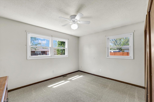 2240 Marilyn Dr, Saint Joseph, IL 61873 - carpeted empty room with a ceiling fan, baseboards, and a textured ceiling
