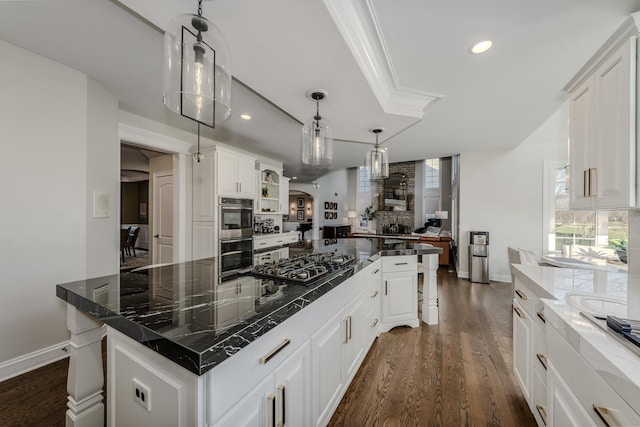 kitchen featuring dark wood-style floors, arched walkways, backsplash, and white cabinetry