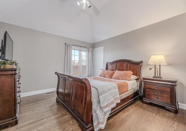 bedroom with light wood-style flooring, visible vents, baseboards, and ceiling fan