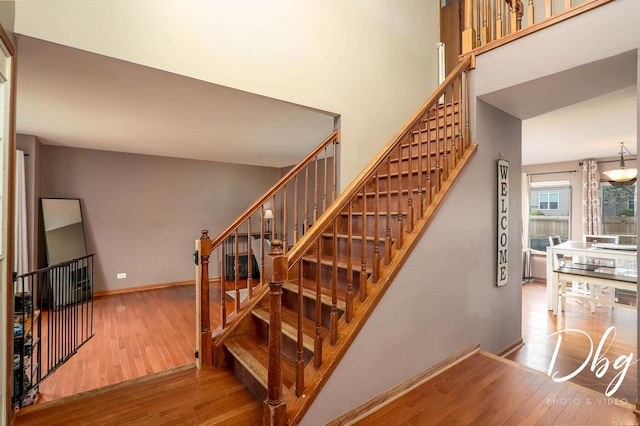 stairs with baseboards and hardwood / wood-style floors