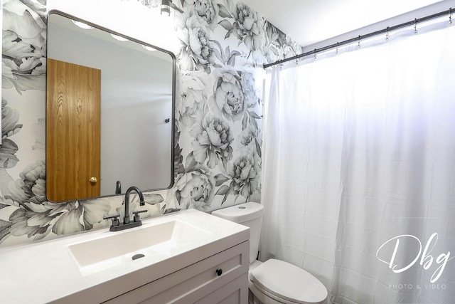 full bath featuring toilet, a shower with shower curtain, and vanity