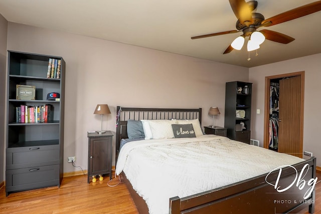 bedroom featuring light wood-type flooring, a ceiling fan, baseboards, and visible vents