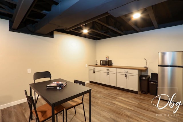 dining room with baseboards and wood finished floors