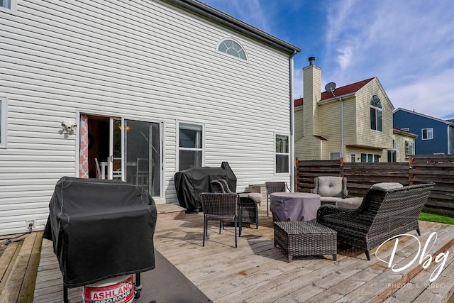 deck featuring outdoor lounge area, fence, and a grill